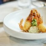 close-up photography of cooked shrimp on round white ceramic plate